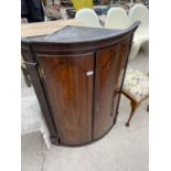 A GEORGE III OAK BOWFRONTED CORNER CUPBOARD WITH SHAPED SHELVES, 32" WIDE