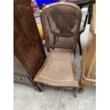 A MAHOGANY NURSING CHAIR WITH RATTAN SEAT AND BACK