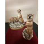 TWO FIGURINES OF OTTERS BY ARENA HANDPAINTED BY A W RILEY 1980 AND J BRADBURY 1981