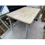 A MODERN KITCHEN TABLE ON PAINTED LEGS