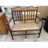 AN EDWARDIAN MAHOGANY AND INLAID PARLOUR SETTEE