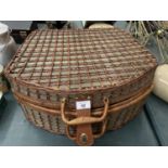 A LARGE WICKER PICNIC BASKET CONTAINING PLATES, CUPS AND CUTLERY FOR FOUR PEOPLE