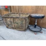 A VINTAGE LAUNDRY CRATE ON A CAST IRON FRAME TO ALSO INCLUDE A VINTAGE FOUR WHEELED PADDED STOOL