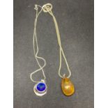 TWO SILVER NECKLACES ONE WITH AN ORANGE DROP PENDANT AND ONE WITH A BLUE CIRCULAR