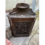 A LATE VICTORIAN OAK CORNER CUPBOARD WITH HEAVILY CARVED SINGLE DOOR AND SHAPED INTERIOR SHELF,