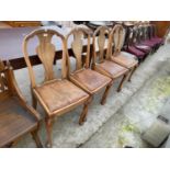 A SET OF FOUR WALNUT QUEEN ANNE STYLE DINING CHAIRS