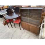 A DINING TABLE AND FOUR CHAIRS BY MORRIS OF GLASGOW AND A TWO DOOR GLAZED BOOKCASE WITH CUPBOARD