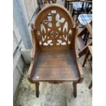 A VICTORIAN GOTHIC OAK CHAIR BY URQUHART & ADAMSON OF LIVERPOOL, HAVING PIERCED BACKA ND SIDE PANELS