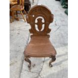 A VICTORIAN HALL CHAIR ON FRONT CABRIOLE LEGS