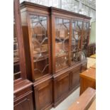 A REGENCY STYLE ASTRAGAL GLAZED FOUR DOOR BREAK FRONT BOOKCASE WITH BEVEL GLASS, FOUR CUPBOARDS TO