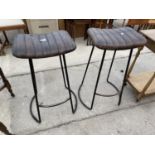 A PAIR OF TALL STOOLS ON METALWARE BASES AND LEATHER SEATS