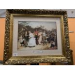 A ORNATE GILT FRAMED PICTURE 'THE VILLAGE WEDDING'