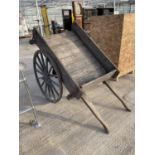 A VINTAGE WOODEN TWO HANDLED AND TWO WHEELED CART