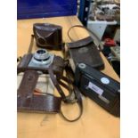 THREE VINTAGE CAMERAS WITH LEATHER CASES