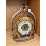 A VINTAGE DECORATIVE CLOCK WITH HORSE SHOE DECORATION