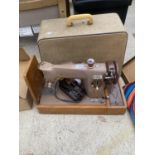 A VINTAGE SINGER SEWING MACHINE WITH CARRY CASE