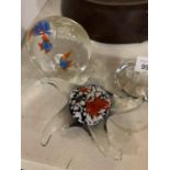 THREE GLASS PAPERWEIGHTS, ONE IN THE SHAPE OF A STAR FISH