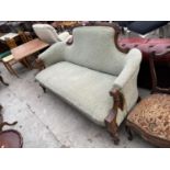 A VICTORIAN WALNUT COUCH WITH FLUTED ARMS HAVING FOLIATE DECORATION AND CARVED TOP RAIL