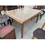 AN EARLY 20TH CENTURY PARTIALLY LIMED OAK DRAW-LEAF DINING TABLE ON TAPERED LEGS WITH INSET CRISS