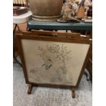 AN OAK FRAMED NEEDLE WORK FIRESCREEN