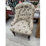 A VICTORIAN NURSING CHAIR WITH BUTTON-BACK ON OAK BARLEYTWIST FRONT LEGS