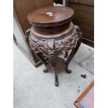 AN ORIENTAL STYLE CARVED JARDINIERE STAND WITH LOWER SHELF