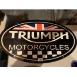 A LARGE OVAL METAL 'TRIUMPH' MOTORCYCLES SIGN 61CMS