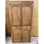 A LARGE WOODEN CUPBOARD ENCLOSING UPPER CUPBOARD, TWO SHORT DRAWERS AND LOWER CUPBOARDS