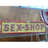 AN ILLUMINATED 'SEX-SHOP' SIGN