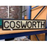 AN ILLUMINATED 'COSWORTH' SIGN