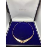 A 9 CARAT THREE COLOUR GOLD CLEOPATRA STYLE NECKLACE APPROXIMATE WEIGHT 6.2 GRAMS IN A