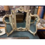 AN ORNATE CREAM AND GILT TRIPLE DRESSING TABLE MIRROR