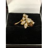 A DECORATIVE ABSTRACT DESIGN 18 CARAT GOLD DIAMOND CLUSTER RING 3.47G APPROXIMATELY 60 PTS SIZE: O