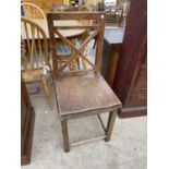 A 19TH CENTURY OAK SINGLE DINING CHAIR WITH 'X' FRAME BACK AND SOLID SEAT