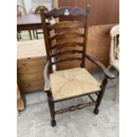 A REPRODUCTION LADDERBACK ELBOW CHAIR