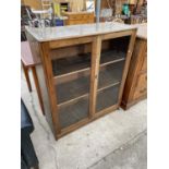 A BEECH FRAMED TWO DOOR GLAZED BOOKCASE