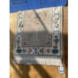 A RECTANGULAR CREAM PATTERNED RUG