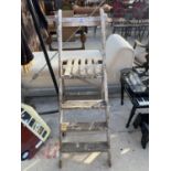 A PAIR OF VINTAGE THREE RUNG SMALL WOODEN STEP LADDERS