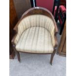 AN EDWARDIAN MAHOGANY AND INLAID TUB CHAIR ON BRASS CASTERS