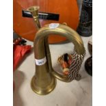 A VINTAGE BRASS MILITARY BUGLE WITH BRAIDED CORD AND TASSELS