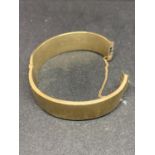 A 9 CARAT GOLD BANGLE MARKED WAX FILLED GROSS WEIGHT 39.4 GRAMS