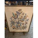 A FLORAL NEEDLEWORK FIRE SCREEN