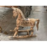 A SMALL WOODEN ROCKING HORSE FOR DECORATION PURPOSES