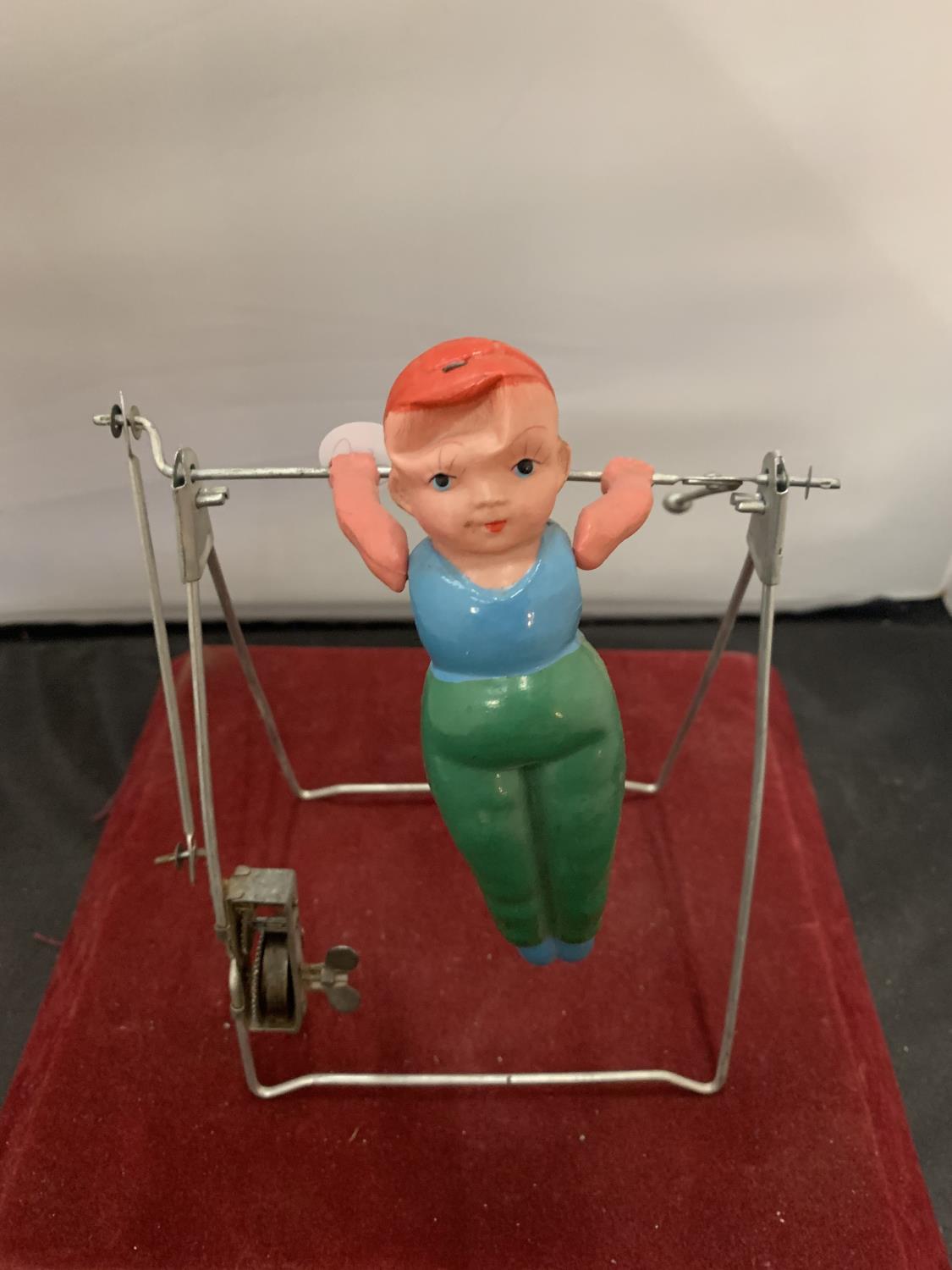 A 1950s GYRATING TOY IN THE FORM OF A GYMNAST