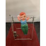 A 1950s GYRATING TOY IN THE FORM OF A GYMNAST