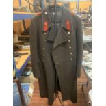 A RUSSIAN SOVIET MILITARY GREAT COAT, TOGETHER WITH A METAL STAND