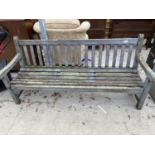 A WOODEN SLATTED GARDEN BENCH