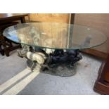 A MODERN OVAL GLASS COFFEE TABLE, THE BASE IN THE FORM OF FOUR REARING HORSES