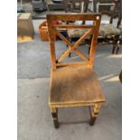 A 19TH CENTURY OAK SINGLE DINING CHAIR WITH 'X' FRAME BACK AND SOLID SEAT