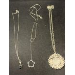 THREE SILVER NECKLACES WITH PENDANTS TO INCLUDE A SIXPENCE, FLOWER AND BLACK STONE
